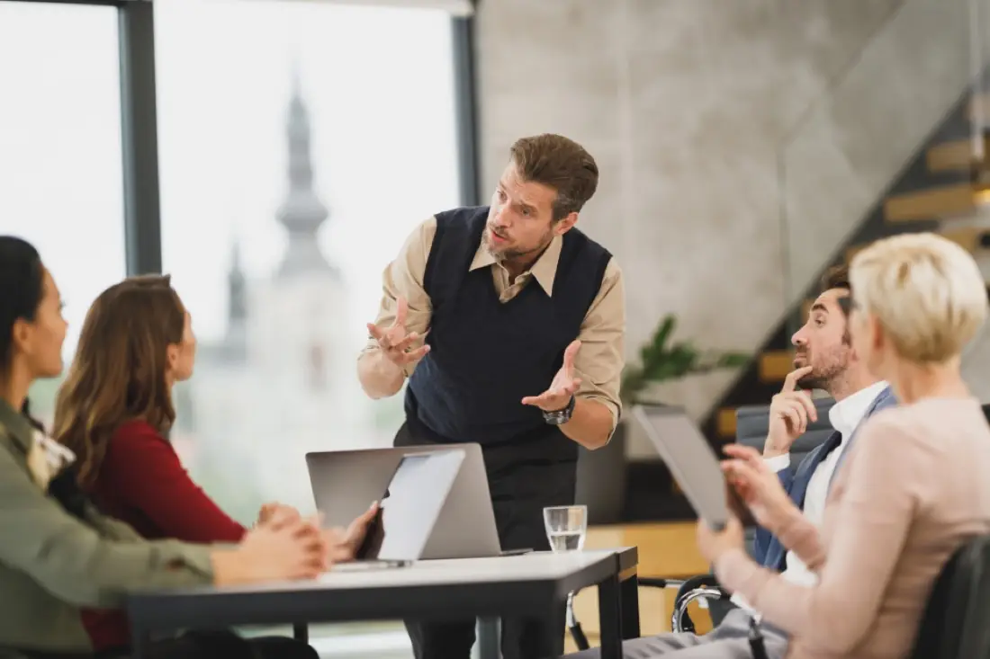 Trainer teaching a group of learners around a table
