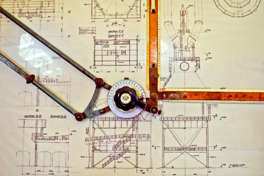 Detailed technical drawing with drafting compass and mechanical layouts